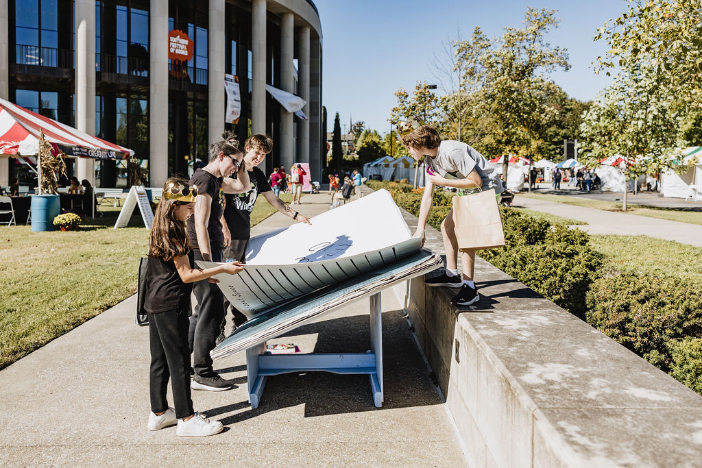 Group turning a giant book page